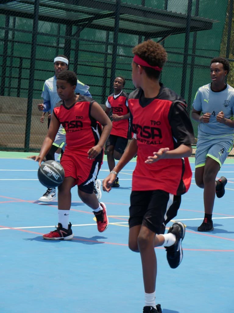 ANSA Basketball players in action on an outdoor court